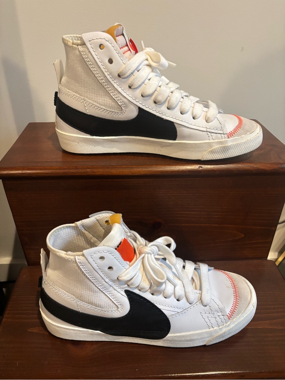 Nike White High-Top Sneakers with Black Swoosh and Orange Tongue Tab